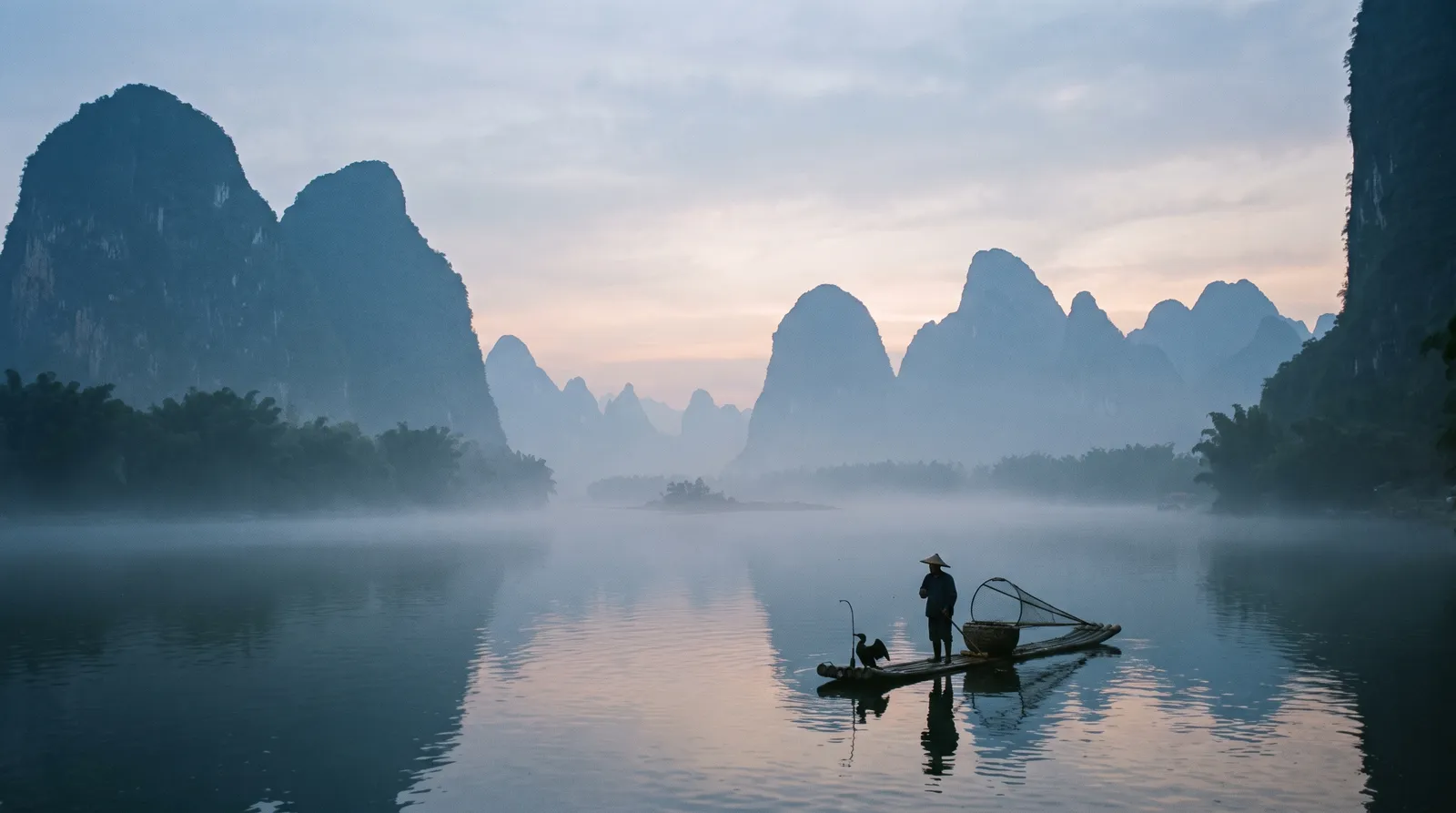 Guilin karst mountains along the Li River at dawn, layered silhouettes fading into mist, a lone bamboo raft with a fisherman and cormorant, soft blue-grey tones, serene