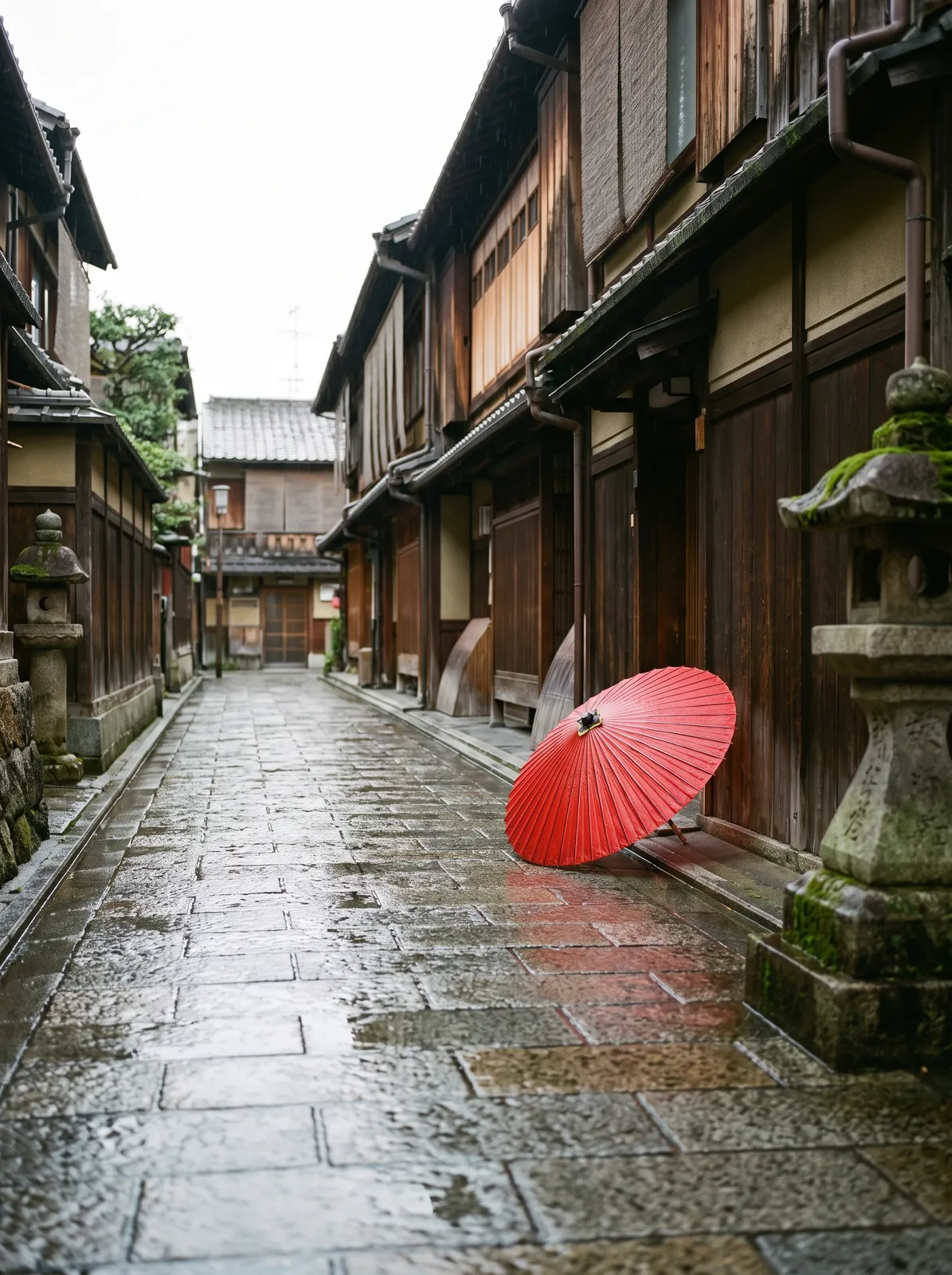 City: a quiet Kyoto backstreet after rain with wet stone paving, a wooden machiya and a single red umbrella, soft overcast light