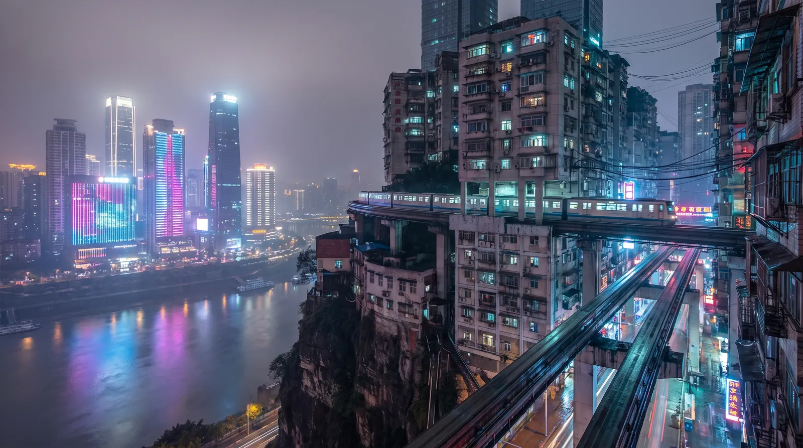Chongqing at night, layered city built on cliffs with light rail passing through a building, glowing skyscrapers and river reflections, cyberpunk real city
