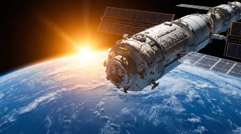 Hard science fiction shot of a Chinese space station module orbiting above the Pacific at sunrise, earth's curved horizo