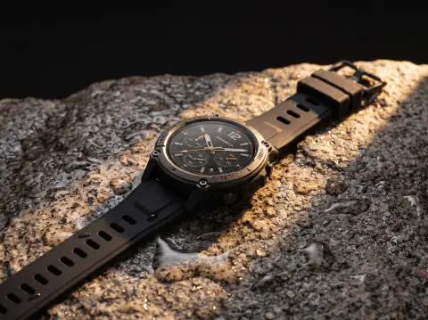 Smartwatch with a black strap on a wet granite surface, water droplets, dramatic side light, tech product photography, d