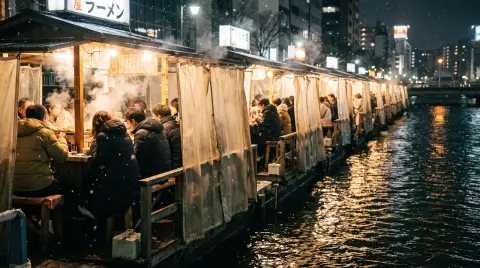 Fukuoka's riverside yatai food stalls on a cold winter night, a row of glowing stalls along the Naka River, steam rising