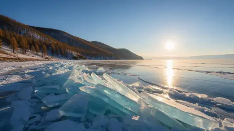 Lake Khövsgöl in northern Mongolia freezing in early winter, slabs of turquoise ice piled along the shore…