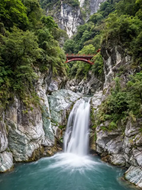Waterfall in Taroko Gorge, Taiwan, marble cliffs, turquoise water, lush green, a small red bridge, vertical composition,